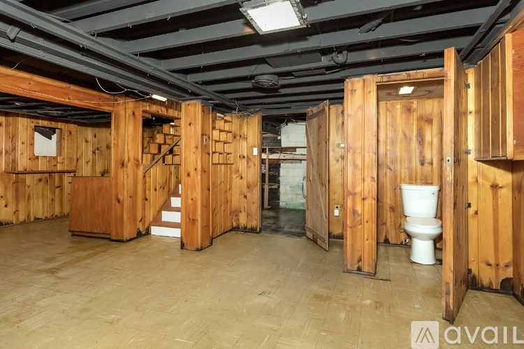 A room under construction with wooden walls and flooring.