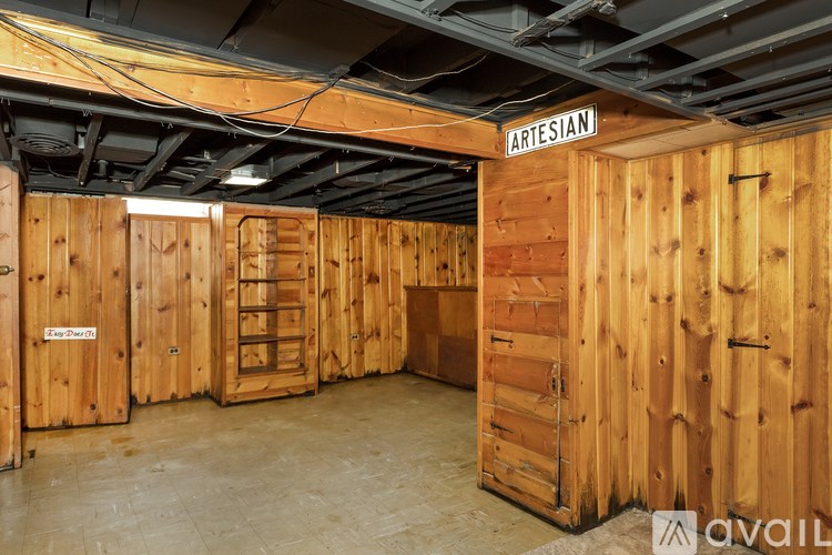 A room with wooden walls and a sign that says "Artisan".