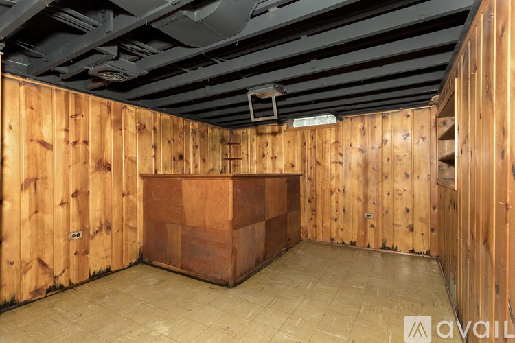 A wooden room with a bar counter in the middle.