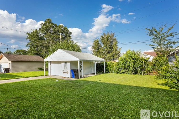 A backyard with a shed and a lawn.