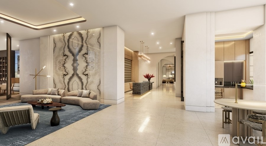 A spacious living room with a large marble wall and a blue rug.