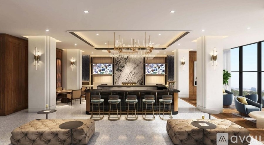 A modern living room with a bar area and a view of the city.