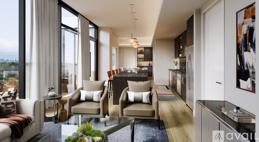 A modern living room with a view of the water outside the large windows.