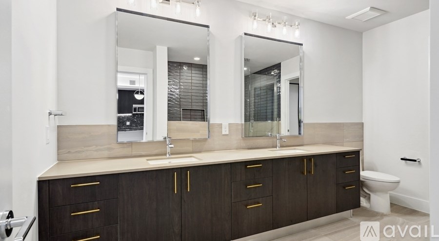 A bathroom with a vanity and a toilet.