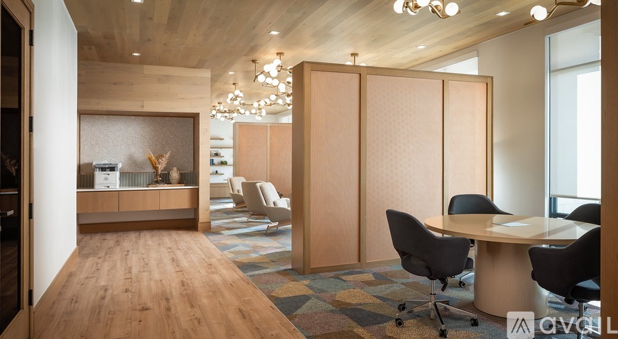 A conference room with a table, chairs and a cabinet.