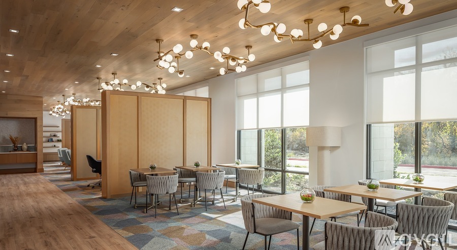 A modern dining room with wooden tables and chairs.