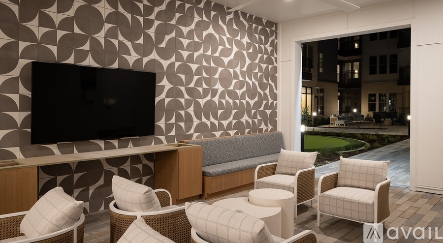 A living room with a television, sofas, and chairs.