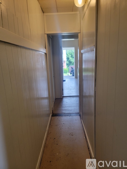 A long hallway with a door at the end.