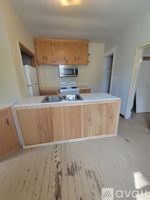 A kitchen with wooden cabinets and a white countertop.