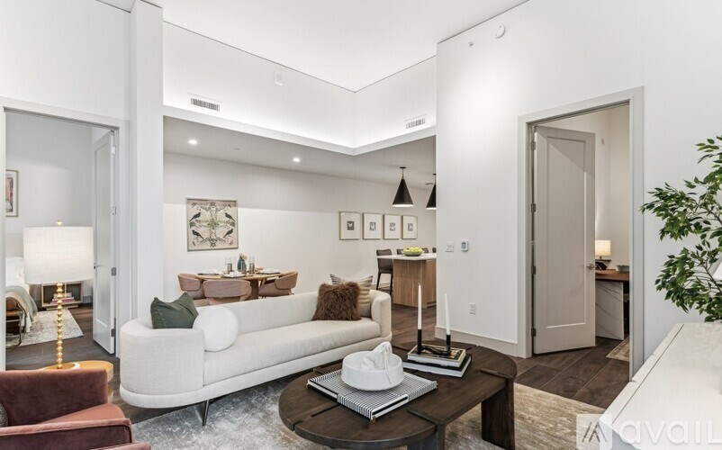 A living room with a white couch and a coffee table.