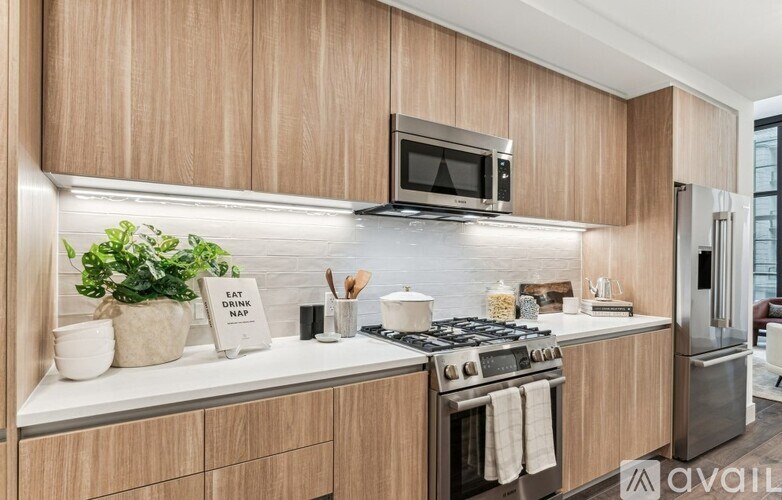 A kitchen with wooden cabinets and a stainless steel stove.