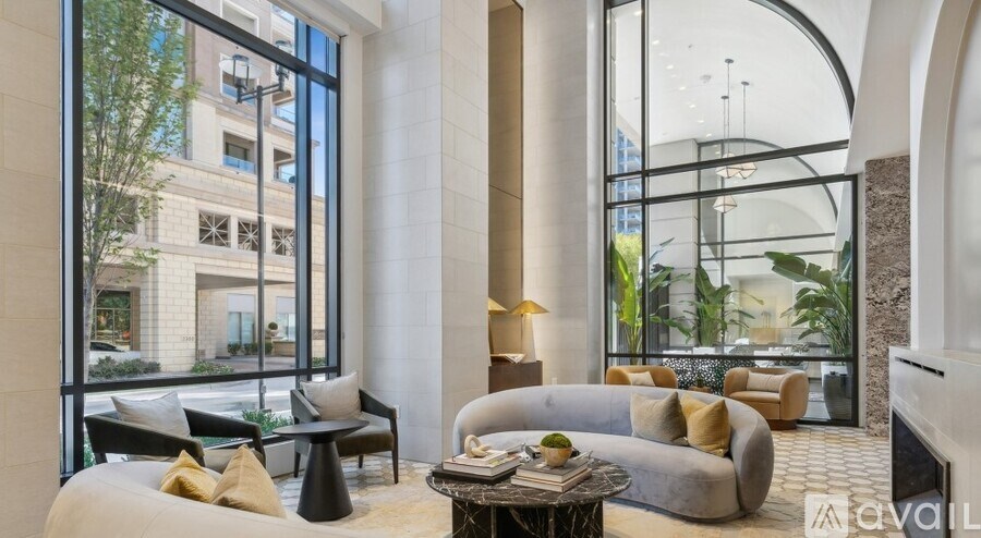 A living room with a large window and a couch.