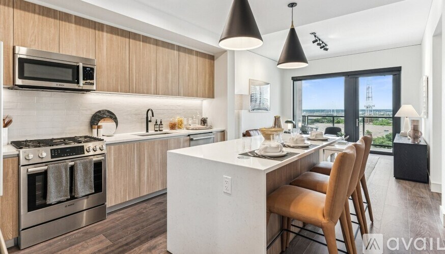 A modern kitchen with a dining table set for four.