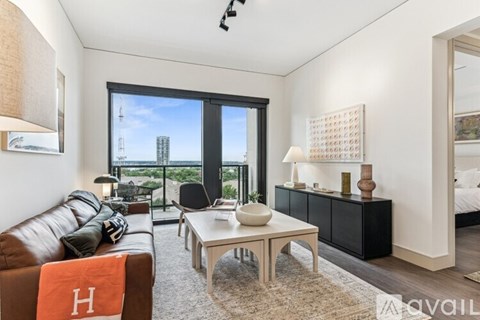 A living room with a brown leather couch and a white coffee table.
