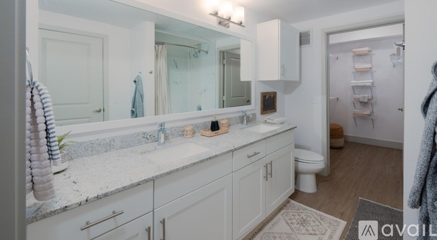 A bathroom with a white countertop and cabinets.