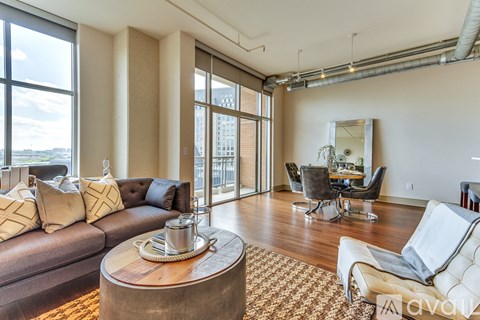A living room with a brown couch and a coffee table.