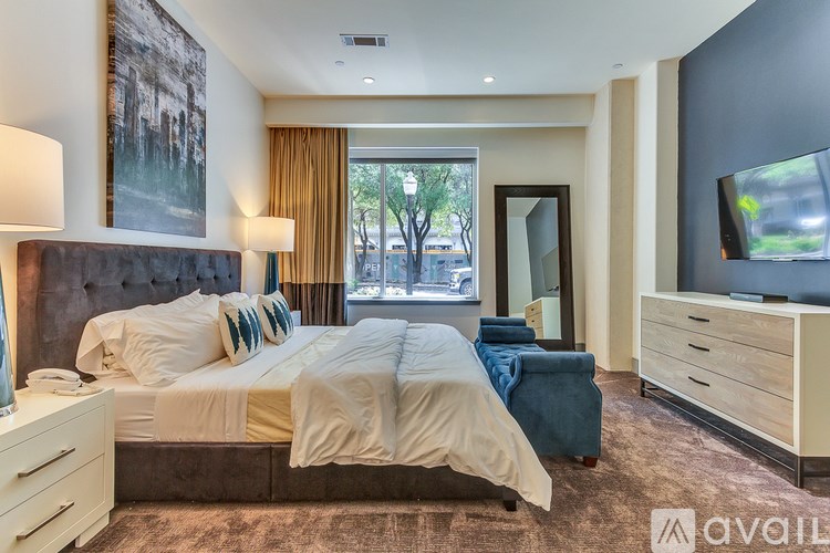 A bedroom with a large bed and a flat screen TV.