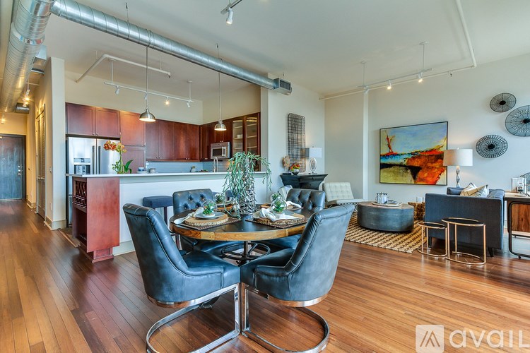A modern dining room with a wooden table and chairs.