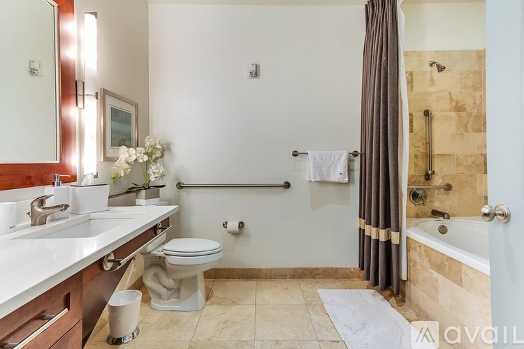 A bathroom with a toilet, sink, and bathtub.