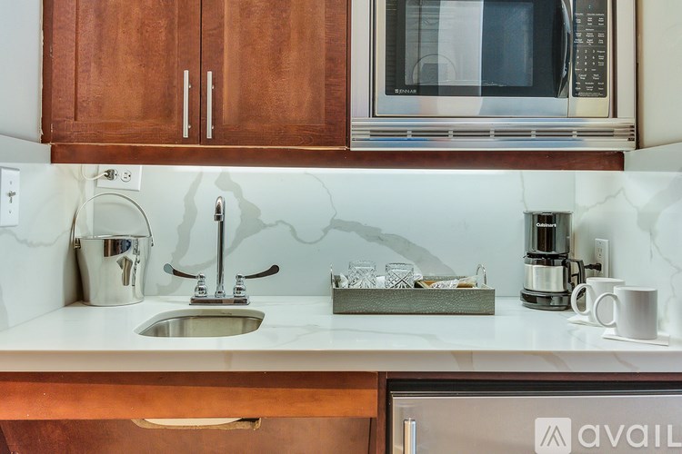 A kitchen with a sink, a microwave, and a coffee maker.