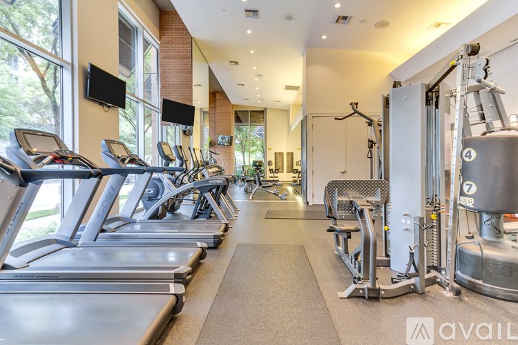 A gym with treadmills, weights, and exercise equipment.