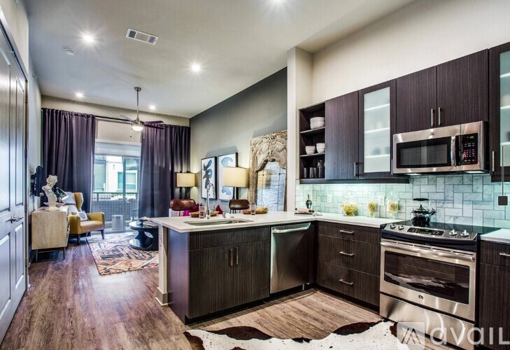 A modern kitchen with dark wood cabinets and stainless steel appliances.