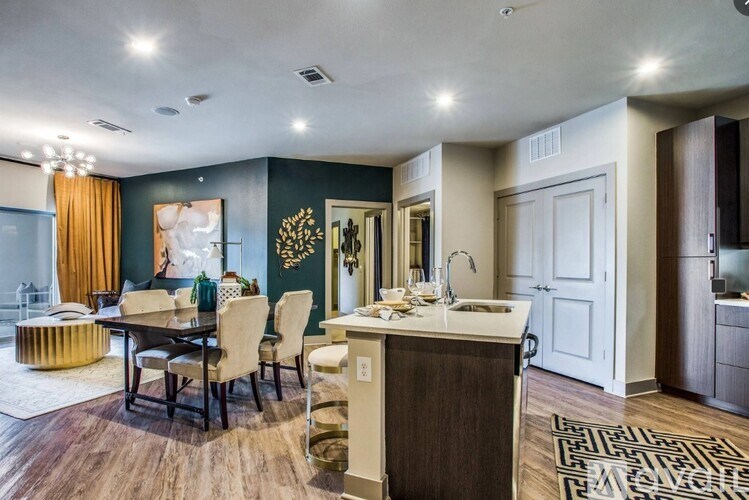A modern kitchen with a dining table and chairs.
