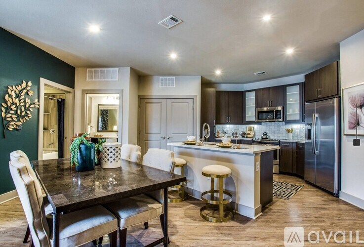 A modern kitchen with a dining table and chairs.
