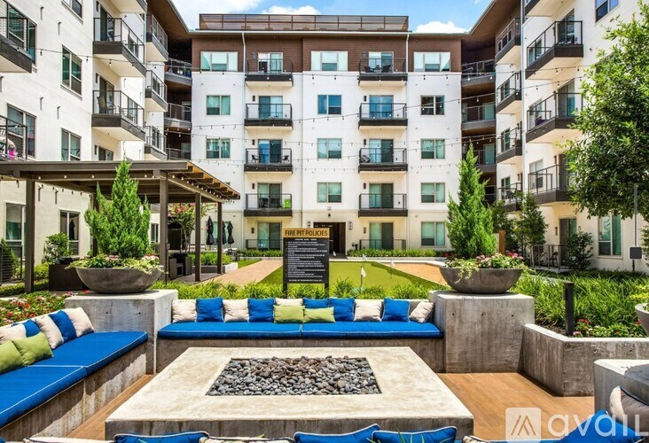 A modern apartment complex with a communal garden area.