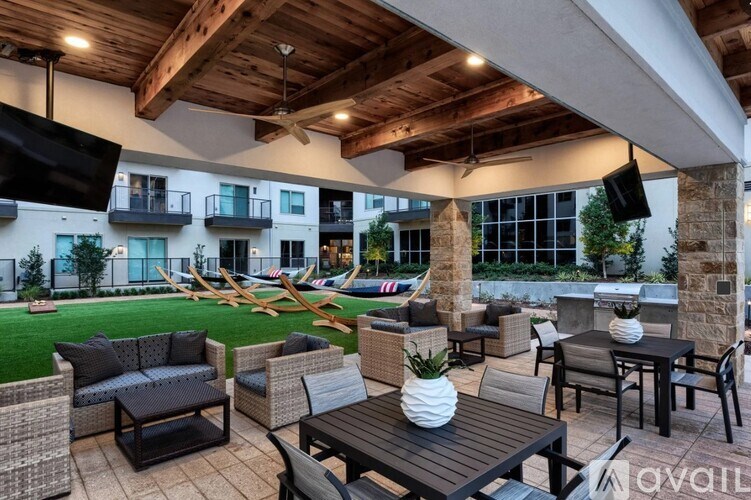 A patio with furniture and a building in the background.