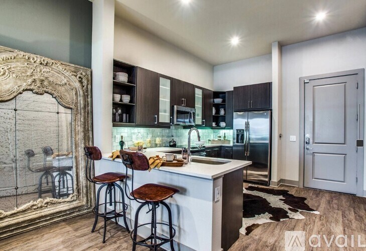 A kitchen with a bar area and a framed mirror on the wall.