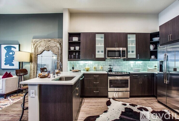 A modern kitchen with dark wood cabinets and a white island.