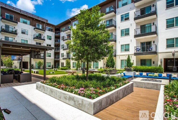 A modern apartment complex with a landscaped courtyard.