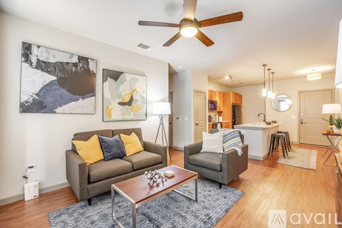 A living room with a grey couch and a coffee table.