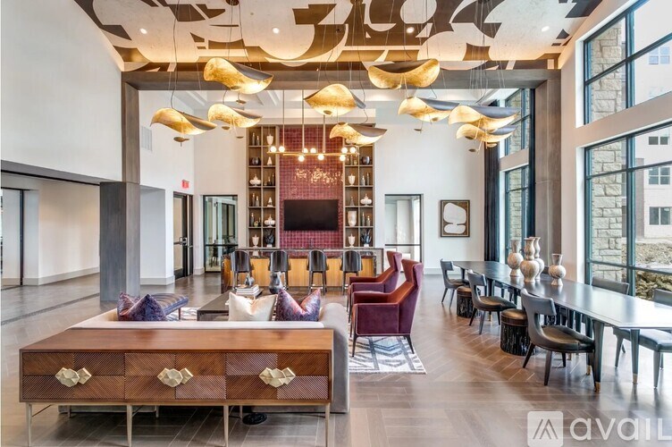 A modern dining room with a long wooden table and chairs.