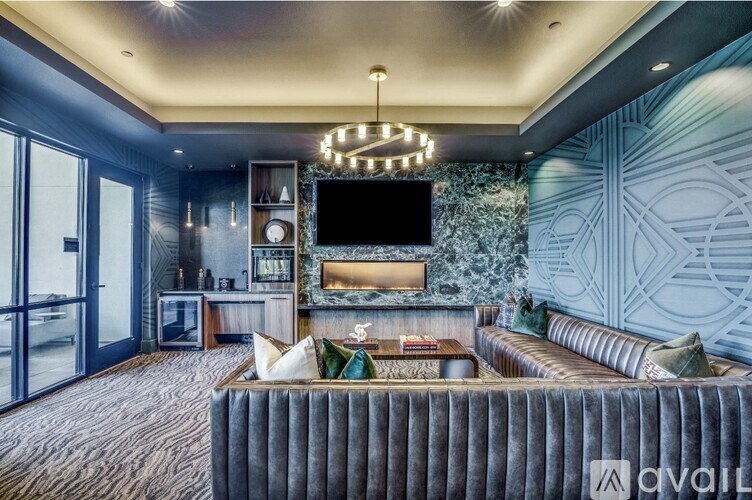 A modern living room with a grey sofa and a television.