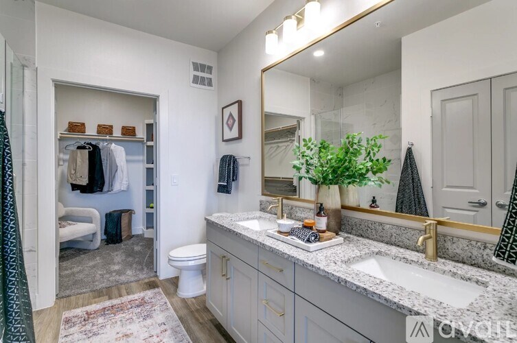 A bathroom with a white toilet, a sink, and a mirror.