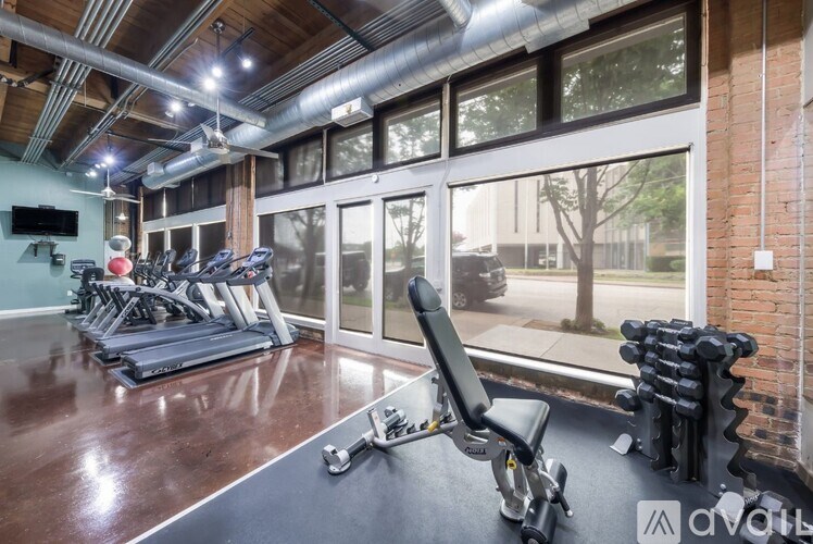 A gym with treadmills, weights, and exercise equipment.