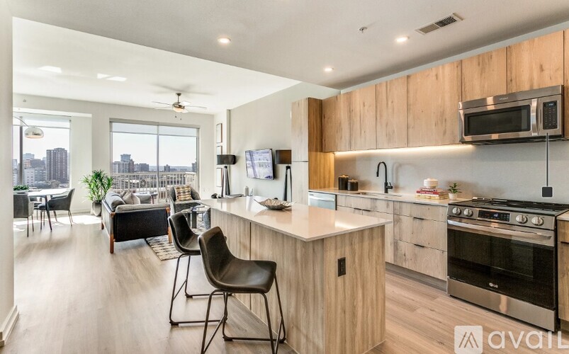 A kitchen with wooden cabinets and a stainless steel oven.