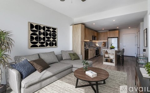 A living room with a grey couch and a brown coffee table.