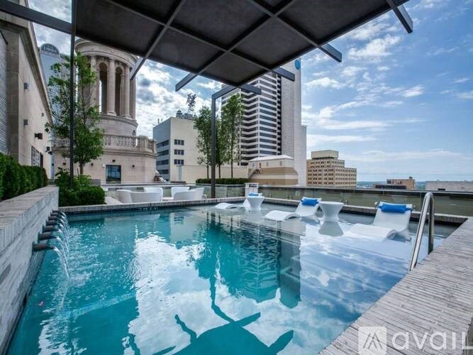 A swimming pool with a view of the city skyline.