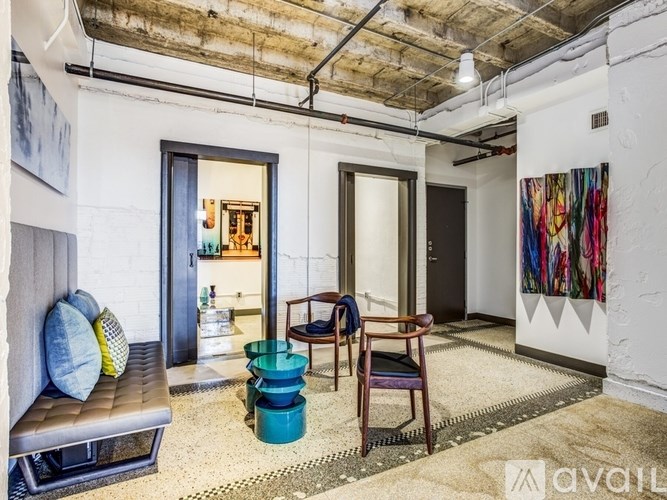 A room with a couch, chair, and a rug.