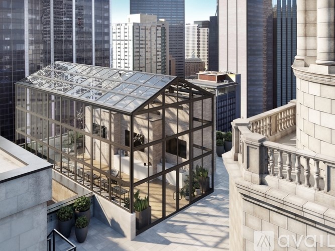 A modern building with a glass roof and a balcony with potted plants.