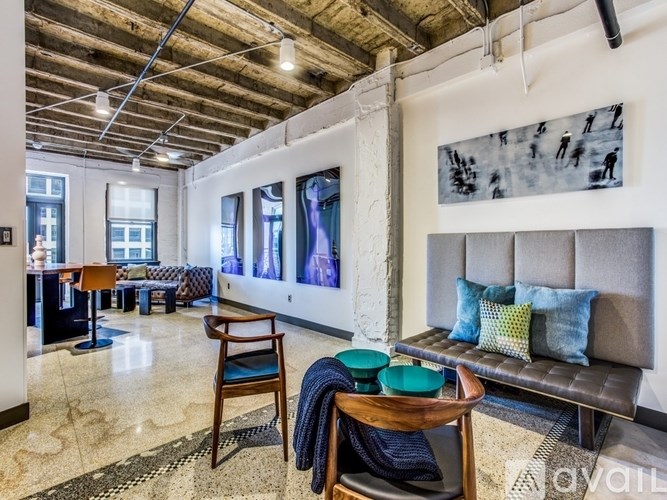 A living room with a couch, chairs, and a coffee table.
