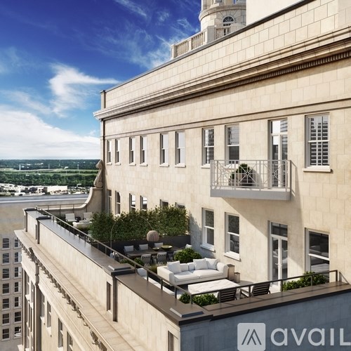 A building with a balcony and a sign that says "avail" on the side.