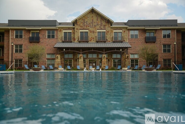 A large building with a pool in front of it.