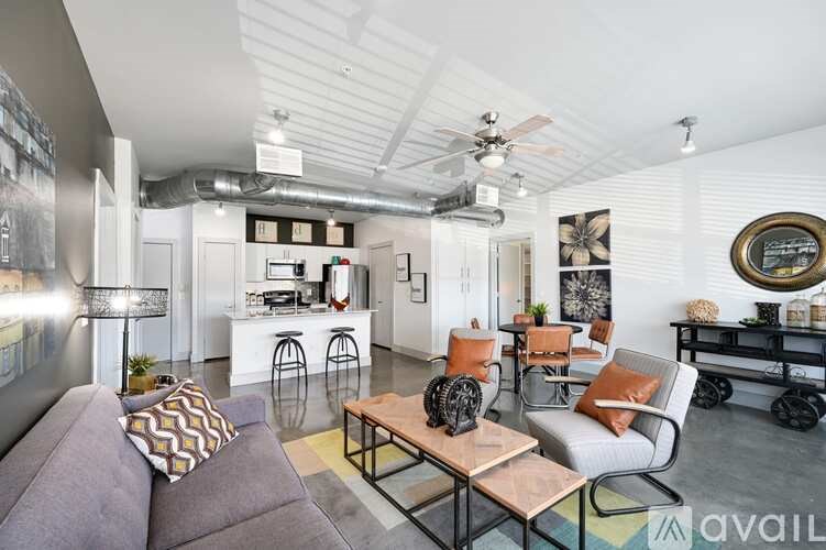 A living room with a grey couch and a coffee table.