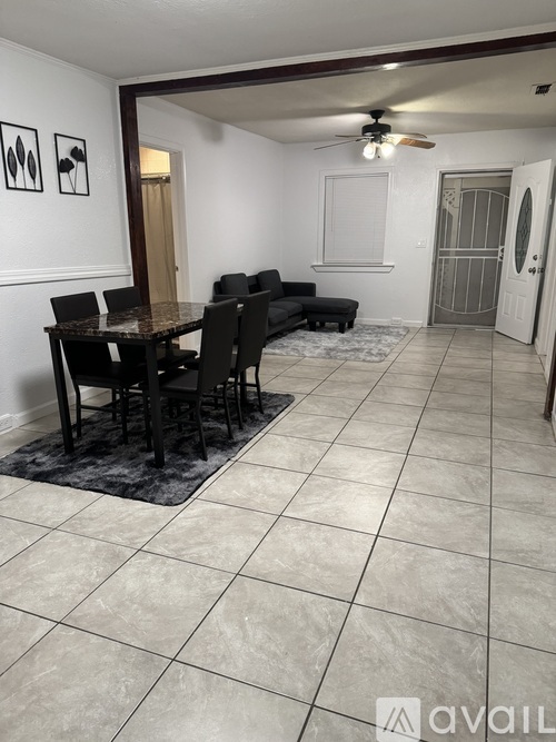 A dining room with a table and chairs.