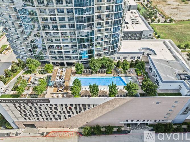 A tall building with a pool in the middle of a courtyard.