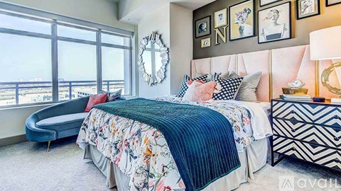 A bedroom with a large bed and a view of the city.